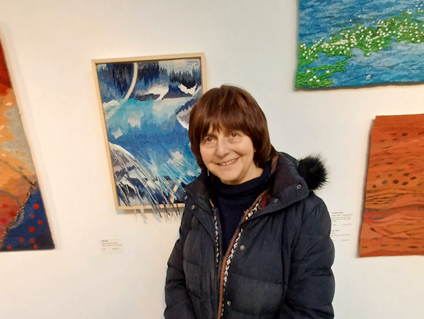 Ruth next to her tapestry “The Making of a Storm”